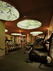 a gym with elliptical machines and ellipticals in a building at KiN Hotel Central Park in Ho Chi Minh City