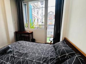 a bedroom with a bed and a large window at LoCo Fully Equipped House - 2BR3WS in Ho Chi Minh City