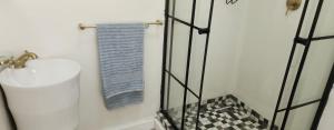 a bathroom with a sink and a blue towel at Riverside Inn in Oranjeville +74 photos