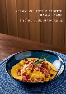 a blue bowl of food on a table at Sireha Cafe Resort and Glamping in Ban Khok Chang