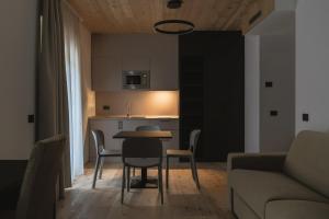 a living room with a table and a couch at Hotel Chalet Rezia in Chiesa in Valmalenco