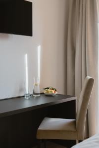 a desk with a chair and a plate of food on it at Hotel Chalet Rezia in Chiesa in Valmalenco
