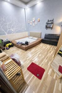 a room with a bed and a couch in it at Nature House Homestay in Ho Chi Minh City