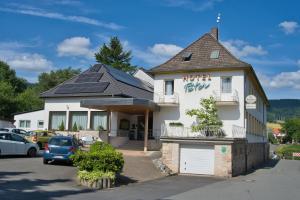a building with solar panels on top of it at Weigands Hotel Peter in Reinhardshagen