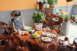 a wooden table with food on top of it at Nature House Homestay in Ho Chi Minh City