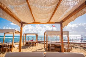 a view of a beach with chairs and the ocean at Pietrablu Resort & Spa - CDSHotels in Polignano a Mare