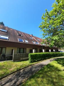 a house with a shingled roof and a driveway at VVF Les Vosges Bitche in Bitche