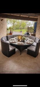 a table with plates of food on a patio at Ferme restaurée de vacance in Xaintrailles
