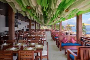 a dining room with wooden tables and chairs at Romhaey Kirirom Resort by EHM in Phumĭ Péam Lvéa