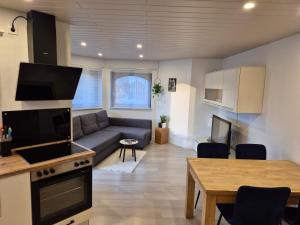 a living room with a couch and a table at Ferienwohnung Familie Aestel in Altensteig +16 photos