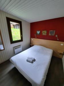 a bedroom with a large white bed with a window at VVF Les Vosges Bitche in Bitche +22 photos