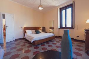 a bedroom with a large bed and a window at Villa Guardini - Lago di Como in Varenna