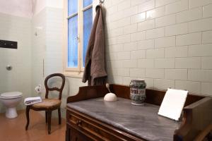 a bathroom with a counter and a toilet and a window at Villa Guardini - Lago di Como in Varenna +92 photos