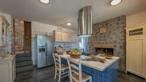 a kitchen with a counter with chairs and a island at Casa Andrea 12 in Orvieto