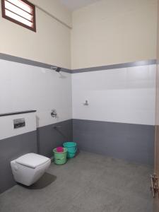 a bathroom with a toilet and two buckets at Bridgettine Paradise in Sultan Bathery +26 photos