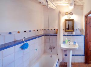 a bathroom with a bath tub and a sink at El Gato Negro in Capileira +40 photos