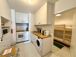 a kitchen with a washer and dryer in a room at Alcácer do Sal Hideaway in Alcácer do Sal