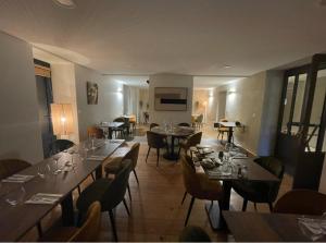 a dining room with tables and chairs in a restaurant at La Table du Musée in Saint-Bonnet-le-Troncy