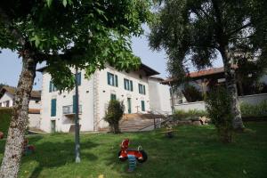 a house with a red bike in the yard at La Table du Musée in Saint-Bonnet-le-Troncy +14 photos