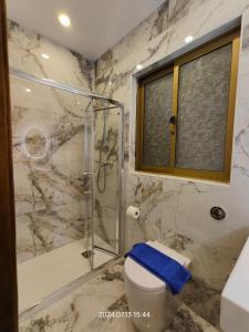 a bathroom with a toilet and a glass shower at Seafront 3 bed Panoramic SeaViews Apt B7- in Qbajjar +20 photos