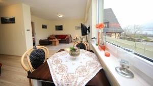 a table and chairs in a room with a balcony at Ferienwohnung Fine in Lorch am Rhein