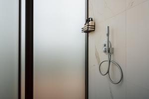 a shower head hanging on a wall next to a door at CR x Rae Golf in Suuresta +16 photos
