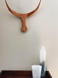 a table with a mirror and a bottle on it at Casa Lonita - Indoor Pool & Spa in Beechworth