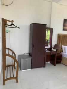 a room with a cabinet and a desk and a chair at Cielstar Resort in Anuradhapura