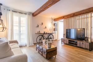 a living room with a flat screen tv and a couch at Eden Provence in Avignon