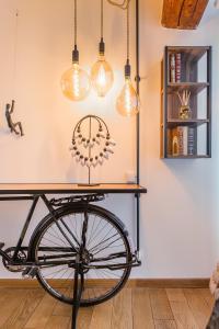 a table with a bike in a room with lights at Eden Provence in Avignon +34 photos