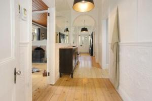 a hallway of a home with a kitchen and a living room at Malakoff House - Charm & Luxury in Beechworth