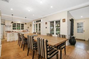 a kitchen and dining room with a wooden table and chairs at Malakoff House - Charm & Luxury in Beechworth