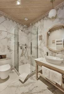 a bathroom with a shower and a toilet and a sink at Willa na Kozińcu Luxury Residence & SPA with Mountain View Zakopane in Zakopane +114 photos