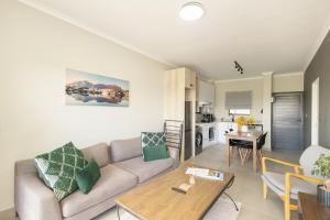 a living room with a couch and a table at Durbanville Daydream in Durbanville