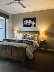a bedroom with a bed and a ceiling fan at The Sunset Deck in Beechworth