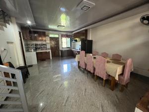 a dining room with a table and chairs and a kitchen at Two-Storey Townhouse in Laguindingan