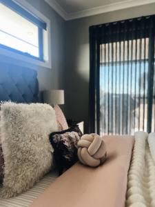 a stuffed animal sitting on top of a bed at The Sunset Deck in Beechworth