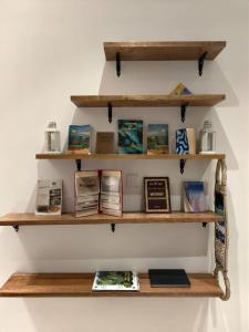 a shelf on a wall with books on it at Bait mutirah guesthouse in Muscat