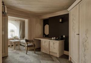 a bathroom with a vanity and a chair in a room at Willa na Kozińcu Luxury Residence & SPA with Mountain View Zakopane in Zakopane