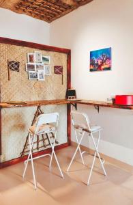 two chairs and a desk in a room at Bait mutirah guesthouse in Muscat