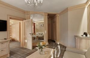 a living room with a couch and a table at Willa na Kozińcu Luxury Residence & SPA with Mountain View Zakopane in Zakopane