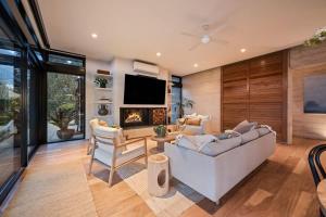 a living room with a couch and a fireplace at The Meldrum in Beechworth