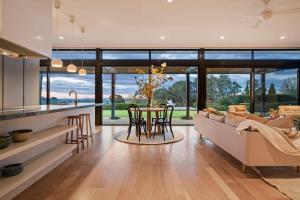 a kitchen and living room with a couch and a table at The Meldrum in Beechworth