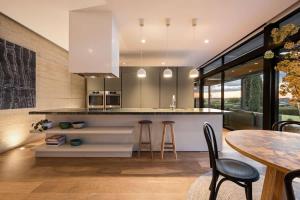 a kitchen with a counter and a table and chairs at The Meldrum in Beechworth
