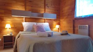 a bedroom with a large bed with wooden walls at VVF Cantal Salers Vendes in Bassignac +46 photos