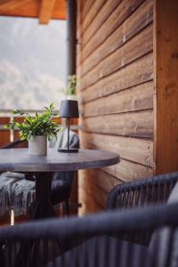 a table with a lamp and a plant on it at Das Bergfrieden Nature Active Hotel in Martello