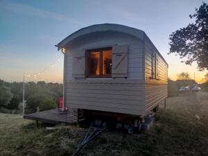 a white tiny house sitting in a field at Rials in Aleyrac