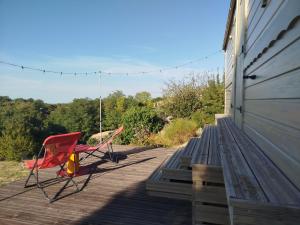 two chairs sitting on the porch of a house at Rials in Aleyrac +41 photos