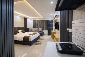 a hotel room with a bed and a couch at The Dreamlight Studio in Dehradun