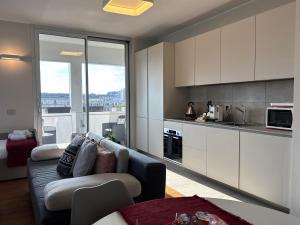 a living room with a couch and a kitchen at Aparthotel Isola in Milan